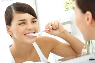 Woman Brushing Her Teeth With A Toothbrush